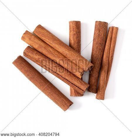 Cinnamon sticks isolated over white background closeup. Canella spice. Aromatic condiment background. Flat lay, top view.