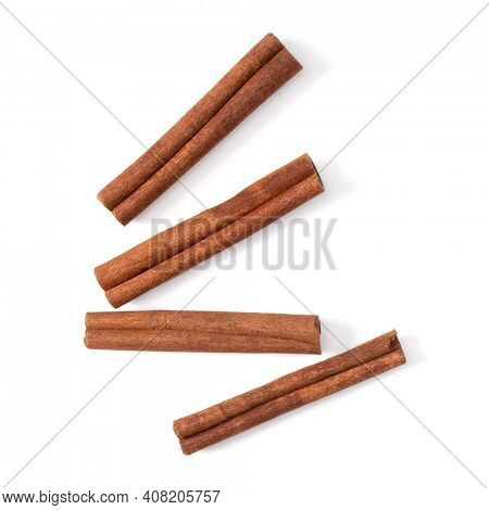 Cinnamon sticks isolated over white background closeup. Canella spice. Aromatic condiment background. Flat lay, top view.