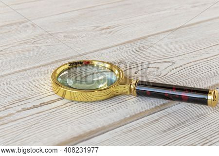 A Magnifying Glass On A Wooden Table. The Concept Of Information Search. Selective Focus