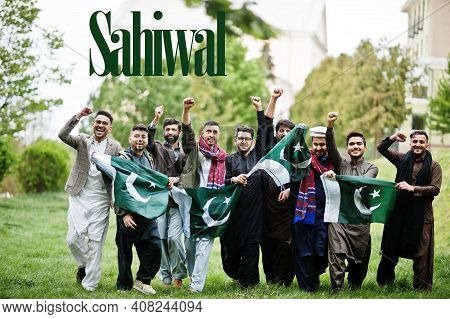 Sahiwal City. Group Of Pakistani Man Wearing Traditional Clothes With National Flags. Biggest Cities