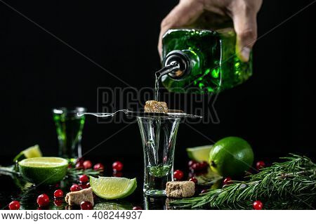 Absinthe Shots With Sugar Cubes. Absinthe Poured Into A Glass. Bottle Of Absinthe With Brown Sugar, 