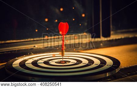 Dart Arrow Hit On Bulleyes Of Dartboard To Represent That The Business Reached The Target  With Dark