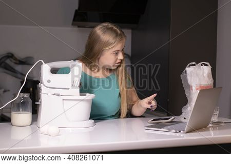 A Blonde Woman Chef Videoblogger Cooking In The Kitchen And Filming, Online Learning Or Remote Cooki