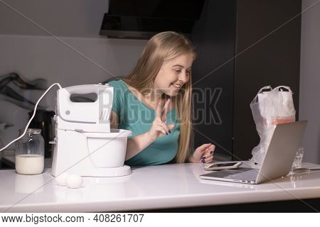 A Blonde Woman Chef Videoblogger Cooking In The Kitchen And Filming, Online Learning Or Remote Cooki