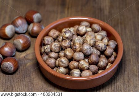 Hazelnuts In The  Bowl On Rustic Wood Table