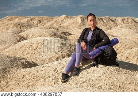 Sports Woman Single Hiker With Backpack Sitts With Blue Bottle On Mountain, Concept Turism, Wellness