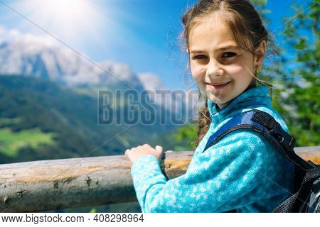 Girl Hiking On Beautiful Summer Day In Alps Mountains Austria, Resting On Rock And Admire Amazing Vi