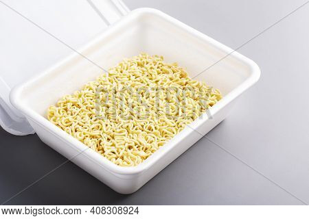 Instant Chinese Noodle On Grey Background. Asian Fast Food, Junk Food, Unhealthy Food. Rolton Or Dos
