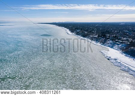 Aerial view of a frozen Lake Michigan from Glencoe Beach with Chicago's skyline seen in the distance after an intense cold spell.