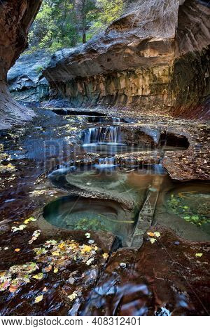 Vertical of small cascades and pools at the entrance to the Subway, a unique tunnel scuplted by the Left Fork of North Creek in Zion National Park, Utah