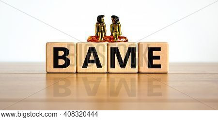 Bame Symbol. Abbreviation Bame, Black, Asian And Minority Ethnic On Wooden Cubes. Two Metalic Angele