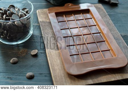 Chocolate Bar Mold Silicone And Chocolate Callets On Table. Low Shallow Focus