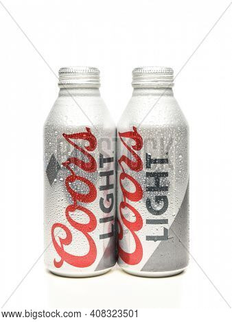 IRVINE, CALIFORNIA - APRIL 15, 22019: Two Coors Light Aluminum Pint Bottles with condensation on white with reflection.