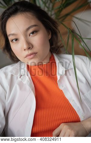 Lifestyle Portrait Fashion Asian Young Woman With Wavy Hair, Highlighted, Wearing White Shirt And Bl