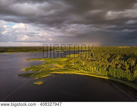 Stromy Clouds Over Eautful Peninsula Between Lakes Snudy And Strusto, National Park Braslau Lakes, B