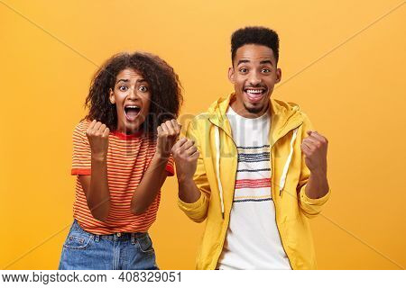 Two Friends Cheering And Supporting Mate On Competition Yelling Joyfully Clenching Fists In Supporti