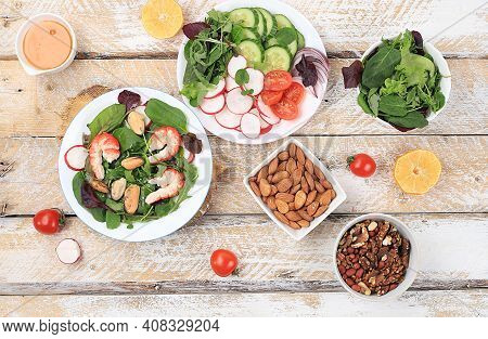 Vegetable Salad With Shrimps, Cucumber, Cherry Tomatoes, Radishes, Honey, Nuts And Fresh Arugula, He