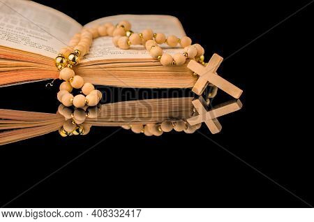 Closeup Of Wooden Christian Cross On Bible And Prayer Beads On Black.church Utensils.