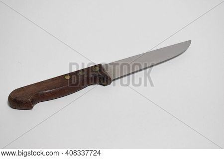 One Kitchen Knife With Wooden Handle Isolated On White Background. A Sharp Stainless Chef's Knife.