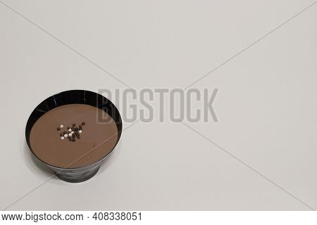 Close Up View Of Fresh Chocolate Pastry Cake In Black Plastic Cake Cup With Crunch Choco Chips On To