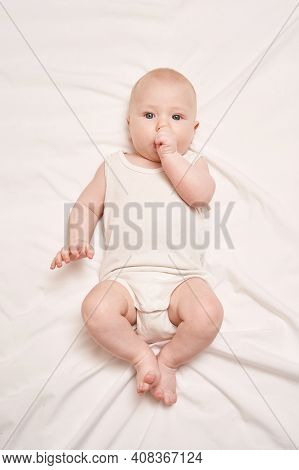Cute Small Boy Lying At Bed. Childhood Concept. Light Background. Serious Child. Copyspace. Stay Hom