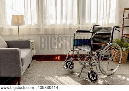 Empty Wheelchair In The Livingroom. Lonely And Healthcare Concept.