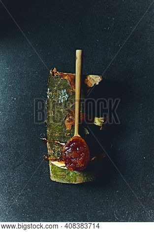 Organic buckwheat honey on a tree bough. Healthy and natural food concept