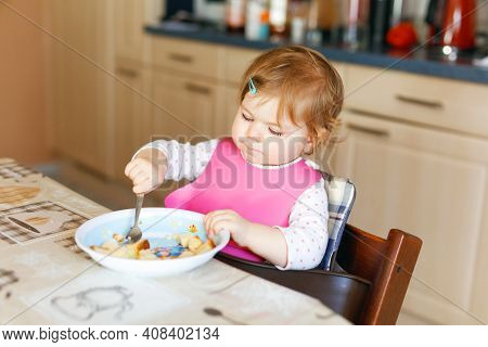 Adorable Baby Girl Eating From Spoon Mashed Vegetables And Puree. Food, Child, Feeding And People Co