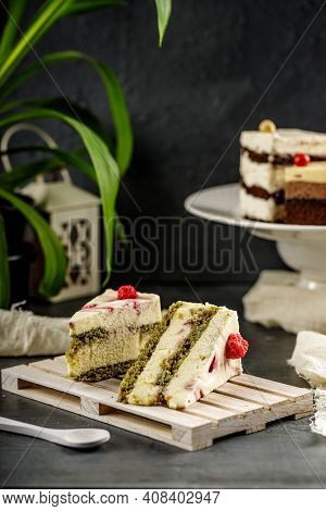 Tasty Cake With Pistachio And Strowberry On The Wooden Pallet. Sweet Homemade Wiped Cream.