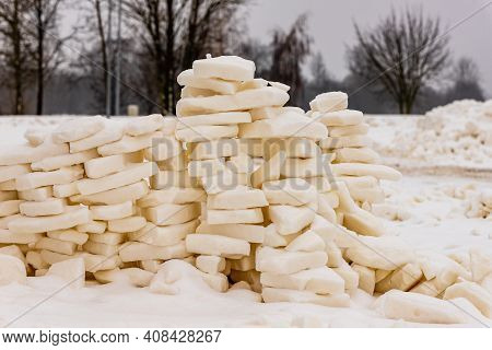 Halfway Built Snow Bricks´ Wall Where From Distance Is Visible Leafless Winter Trees And Two Lamp Po