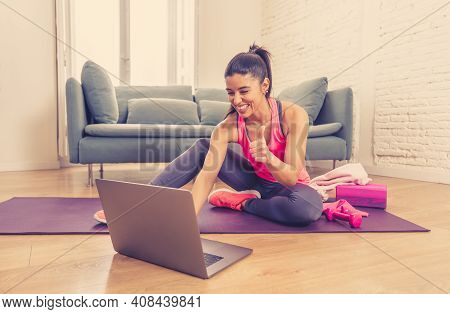 Attractive Woman On Laptop In Virtual Online Fitness Class Working Out At Home