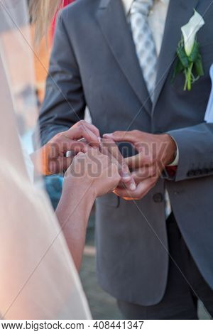Bride And Groom Exchanging Wedding Rings. Stylish Couple Official Ceremony. High Quality Photo