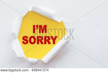 Top View Of White Torn Paper And The Text I'm Sorry On A Yellow Background.