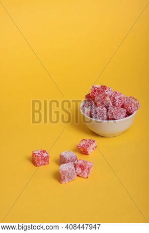 A Bowl Of Rahat Lakoum Isolated On Yellow Background. Turkish Sweet Concept. Image Contains Copy Spa