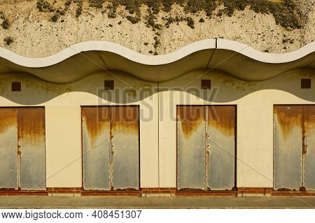 Rusty Iron Doors To Beach Huts On The Promenade Between Brighton Marina And Rottingdean, East Sussex