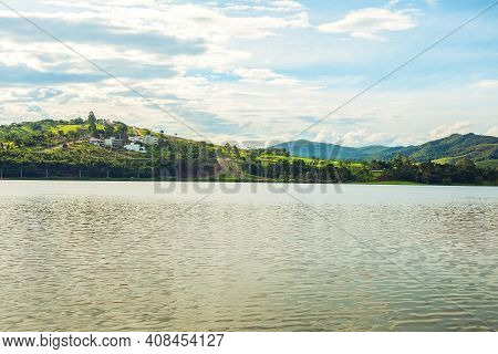 Houses On The Hill Next To A Beautiful Lake, Peaceful Place, Concept Of Place To Live After Retireme