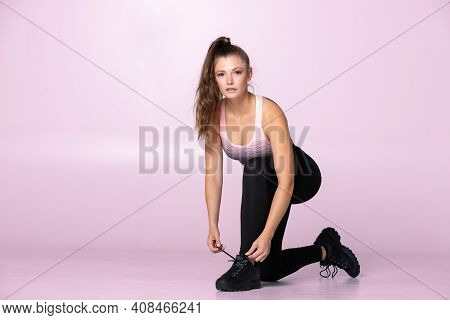 Female Trainer Getting Ready For Lessons And Tie Shoe Kneeling, Taking A Break And Getting Ready For