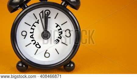 Quality Time Symbol. Beautiful Black Alarm Clock With Words 'quality Time'. Beautiful Orange Backgro