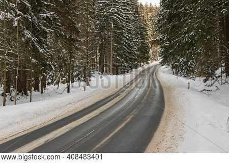 Asphalt Road In Winter, In The Jizera Mountains.\njizera Mountains In Poland. Asphalt Road Covered W