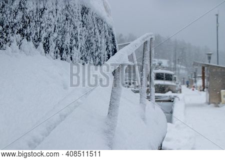Boat And Dock Covered In Snow On A Winter Day In British Columbia