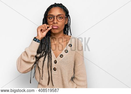 African american woman wearing casual clothes mouth and lips shut as zip with fingers. secret and silent, taboo talking 
