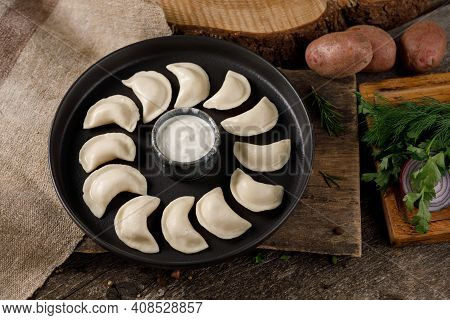 Appetizing Traditional Russian Dumplings, Hand-made With Potatoes. Still Life On A Wooden Board. Clo