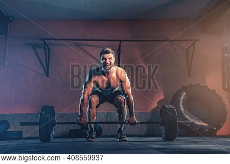 Muscular Fitness Man Doing Push A Barbell Over His Head In His Garage, Selfisolation. Functional Tra