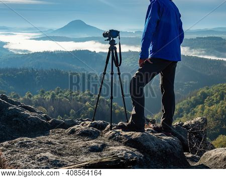 Morning Sun Rays Make Way Through The Clouds And Man Stay At Tripod With Camera And Telezoom Lens Th