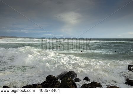 Costa Da Caparica, Portugal - April 17, 2019: Surfing In The Costa Da Caparica Beach, A Famous Place