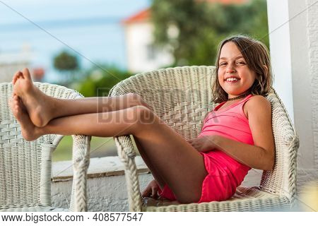 Happy Girl Kid Enjoying Summer Vacation At Sea Resort.