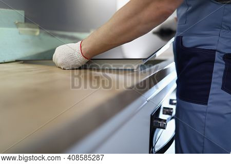 Gloved Craftsman Installs Hob In Kitchen. Household Appliance Installation Services Concept