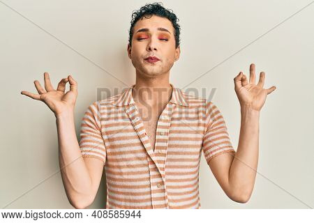 Handsome man wearing make up wearing casual t shirt relax and smiling with eyes closed doing meditation gesture with fingers. yoga concept. 