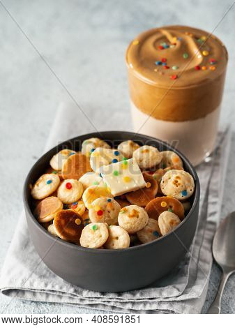Mini Pancakes Cereal And Dalgona Coffee, Gray Cement Background, Copy Space. Trendy Food And Drink -
