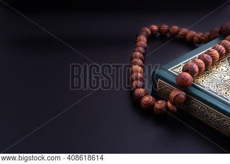 Holy Quran With Arabic Calligraphies Translation Meaning Of Al-quran And Rosary Or Tasbih On Black B